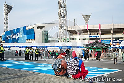 Gangneung, Gangwon province, South Korea - Foreign tourists couple resting on a street in 2018 Pyeongchang Winter Olympics. Editorial Stock Photo