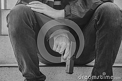 Gangster men holding a gun sitting on stairs. Stock Photo