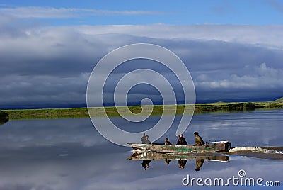 Gansu, China: Four Men in Wooden Boat Editorial Stock Photo