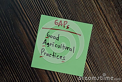 GAPs - Good Agricultural Practices write on a book isolated isolated on Wooden Table Stock Photo