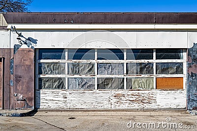 The garage door on the front of a defunct gas station Stock Photo