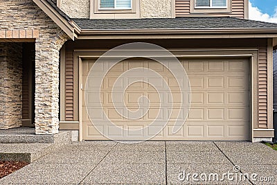 Garage Door. Modern house with garage door that is closed. A perfect neighbourhood. Family house with wide garage door Stock Photo