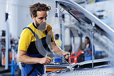 Garage engineer replaces car oil Stock Photo