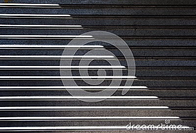 Garage metallic roller shutter with sunlight and shadow Stock Photo