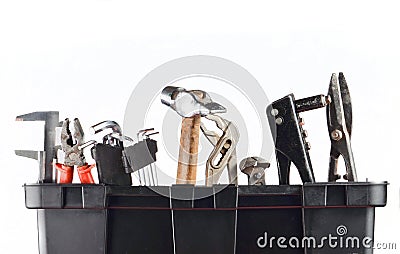 Garage plastic tool box with tools isolated on white. Hammer, forceps, nippers, wrench, metal scissors. Stock Photo