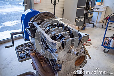 In the garage there is an opened engine block of a car Stock Photo