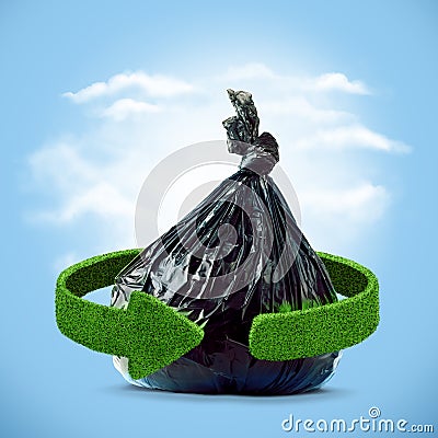 Garbage bag and green arrows from grass. Recycling concept Stock Photo