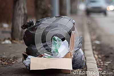 Garbage bags on the edge of the roadside in the city Stock Photo
