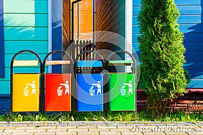 garbage bin of bright color on the street near the house. Stock Photo