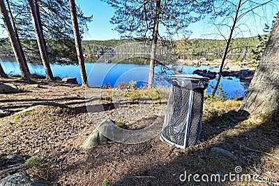 Garbage can near a little lake in Sweden Stock Photo