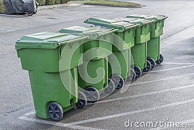 Garbage Cans In A Row Waiting For Dump Truck Stock Photo