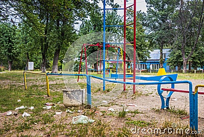 Garbage is on a children`s Playground .Garbage around the rubbish bin Stock Photo