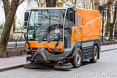 Garbage collection machine on the city streets. The problem of cities is a lot of rubbish. Stock Photo