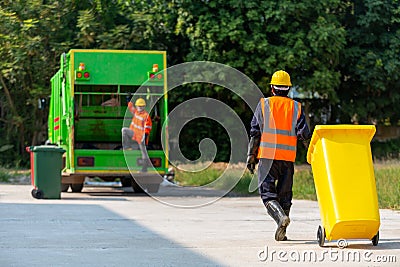 Garbage collector, Garbage man working together on emptying dustbins for trash removal Stock Photo