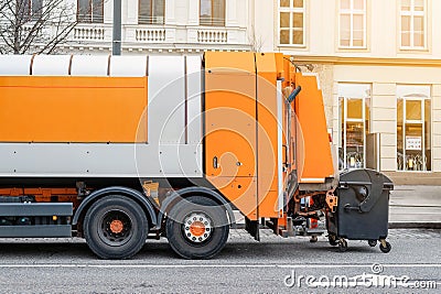 Garbage disposal lorry at city street. Waste dump truck on town road. Municipal and urban services. Waste management, disposal and Stock Photo