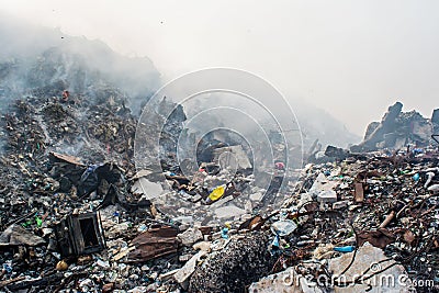Garbage dump area view full of smoke, litter, plastic bottles,rubbish and other trash at the Thilafushi local island Stock Photo