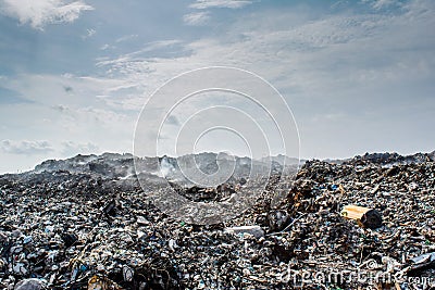 Garbage dump area view full of smoke, litter, plastic bottles, rubbish and trash at the Thilafushi local tropical island Stock Photo