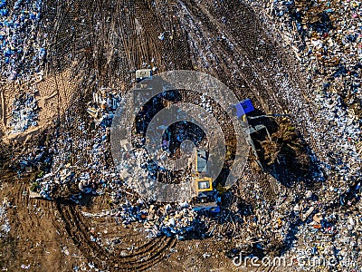 Garbage dump and working dump truck and bulldozer, aerial top view Stock Photo