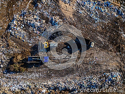 Garbage dump and working dump truck and bulldozer, aerial top view Stock Photo