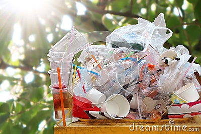 Garbage many close-up on Trash full of trash bin, Plastic bag waste Lots of junk on nature tree sunshine background Stock Photo