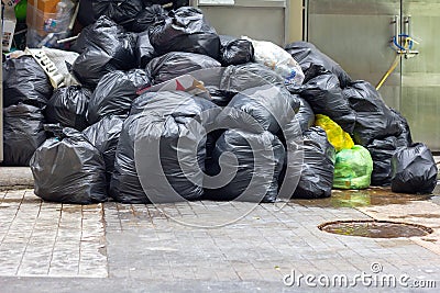 Garbage pile black plastic bags and trash bag waste pollution. Stack of black garbage bags.Black plastic bags for packaging waste Stock Photo