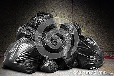 Garbage is pile lots dump, many garbage plastic bags black waste at concrete wall, pollution from trash plastic waste garbage bag Stock Photo