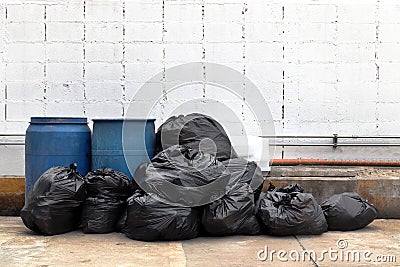 Garbage is pile lots dump, many garbage plastic bags black waste at walkway community village, pollution from trash plastic waste Stock Photo