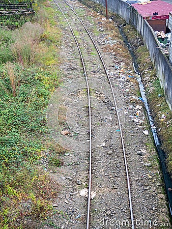 Garbage on the railway Rails and waste. Polluted environment in the city. Industrial zone Stock Photo
