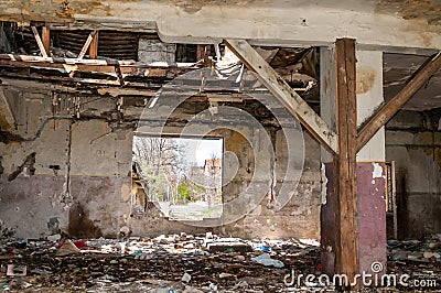 Garbage on the remains of damaged collapsed house polluting the city street with junk and litter Stock Photo