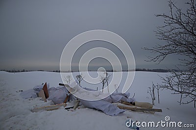 Garbage thrown into the snow along the snowy road Stock Photo