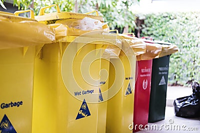 Garbage trash bins, separate wet, danger, dry and recycle waste, selective focus shallow depth of field Stock Photo