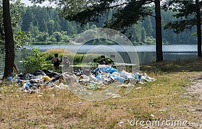 Garbage waste in the woods by the lake Editorial Stock Photo
