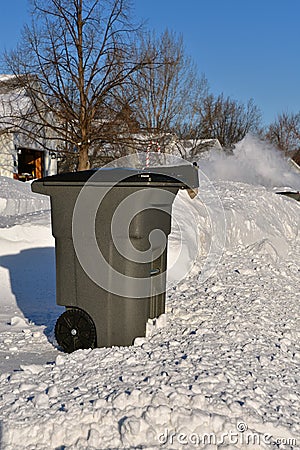 Garbase can sits outside in the snow Stock Photo