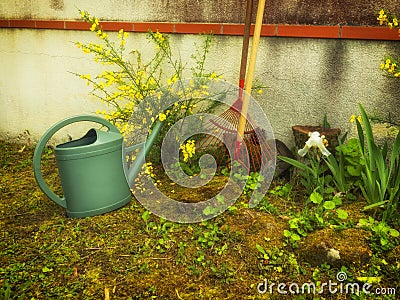 Garden accessories in the garden near the wall of the house. Stock Photo