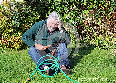 Garden accident. Falling over. Man injured. Stock Photo