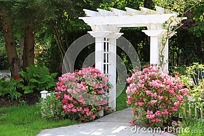 Garden arbor and pink flowers. Stock Photo