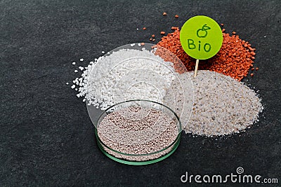 Garden background with mineral fertilizers balls. Complex mineral fertilizer with sodium, phosphorus for flowers, plant, tree Stock Photo