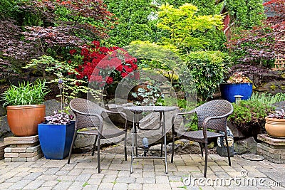 Garden Backyard Landscaping with Bistro Furniture springtime Stock Photo