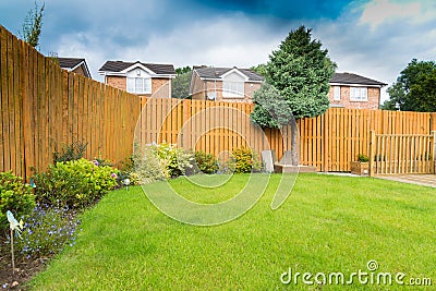 Garden Border with fencing and shrubs Stock Photo