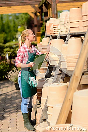 Garden center woman check clay pots Stock Photo