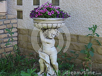 Garden statue with flowers Stock Photo