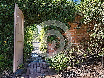 Garden doorway with brick path Stock Photo