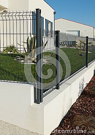 Garden fence and gate in rigid wire mesh panels Stock Photo