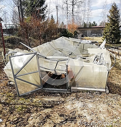 Garden greenhouse destroyed by snow made of transparent polycarbonate Stock Photo