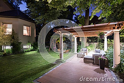 Garden with patio at night Stock Photo