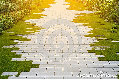 Garden pavement - cobblestone and grass on sidewalk Stock Photo