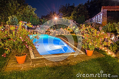 Garden with pool at night Stock Photo