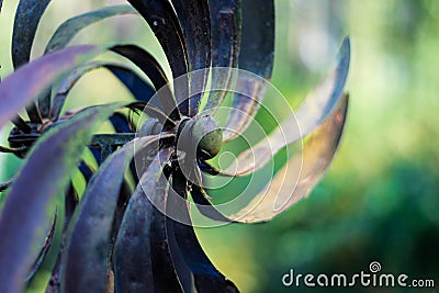 Garden spinner whirligig abstract rusty oxidized brass Stock Photo