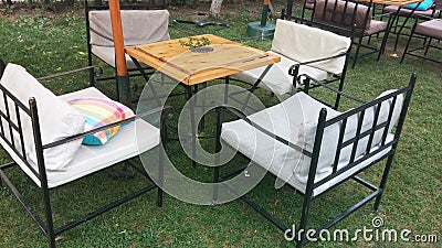 Garden table with iron chairs and sun umbrellas Stock Photo