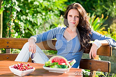 Garden terrace beautiful woman fresh summer fruit Stock Photo